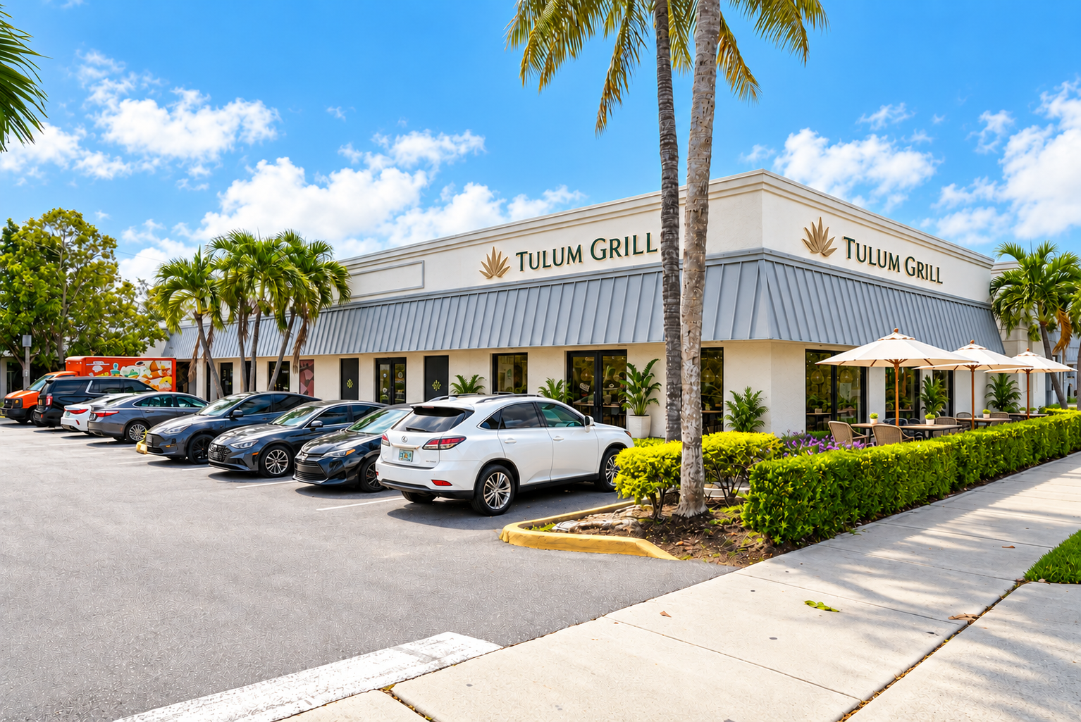 Tulum Grill exterior in Boca Raton with outdoor tables and umbrellas