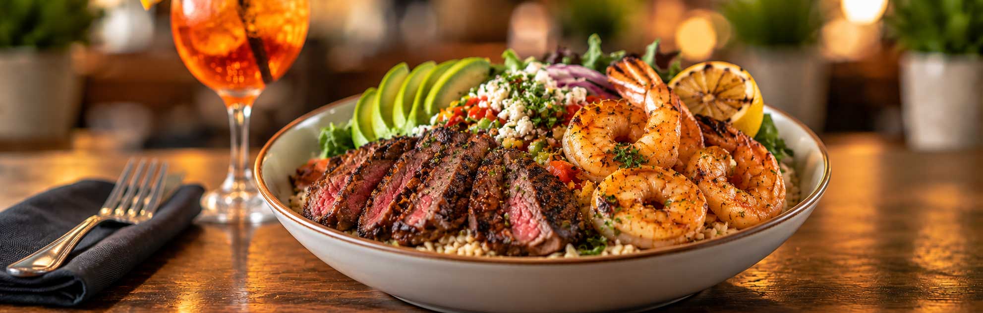 Prime steak and shrimp bowl with Mexican rice and fresh toppings at Tulum Grill in Boca Raton